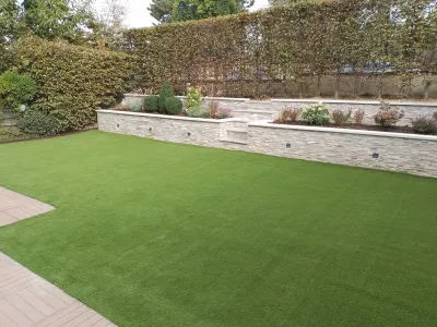 Jardin moderne avec pelouse synthétique et jardinières surélevées