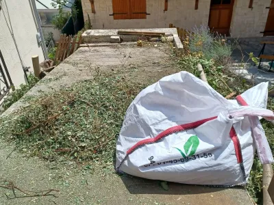 Grand sac rempli de taille de haie et résidus végétaux après entretien de jardin