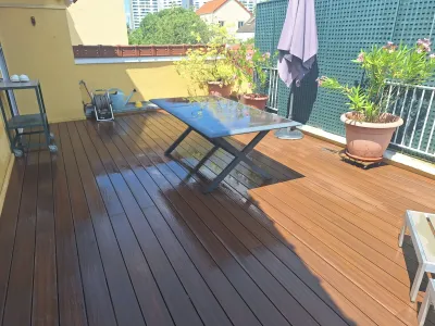 Terrasse en bois aménagée avec table extérieure et plantes en pot